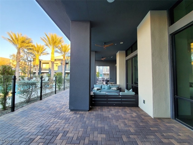 view of patio with an outdoor living space and ceiling fan