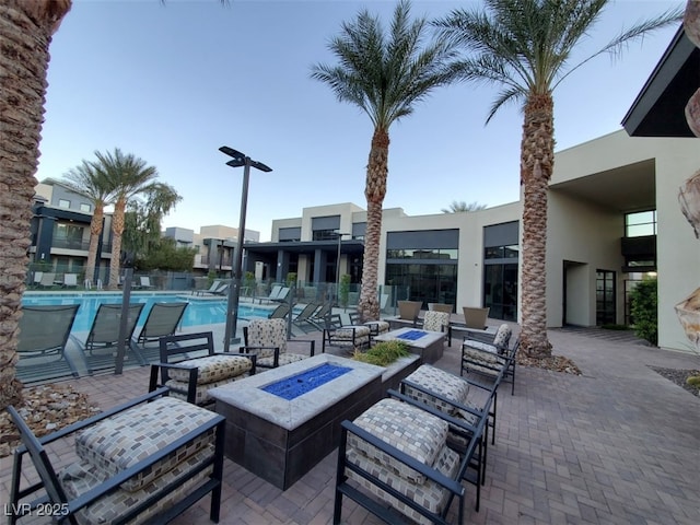 view of patio / terrace with a community pool and a fire pit