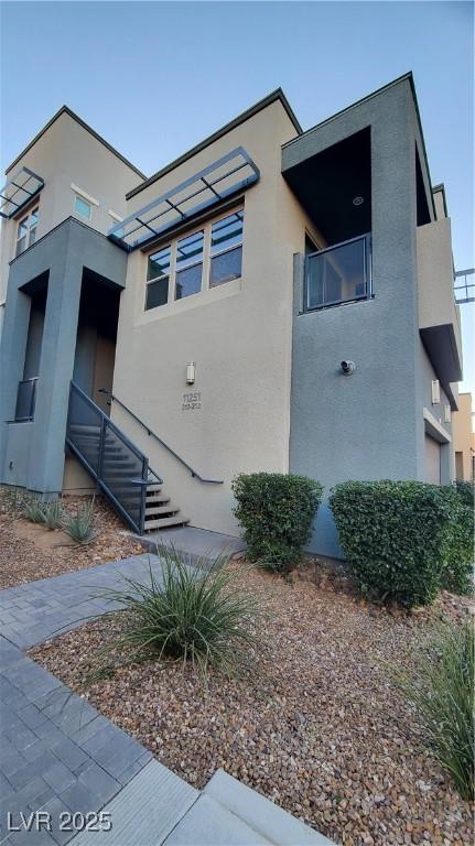 11251 Hidden Peak Ave Unit 212, Las Vegas, NV 89135 - view of side of home with a balcony and stucco siding