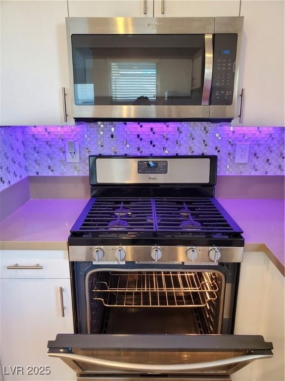 11251 Hidden Peak Ave Unit 212, Las Vegas, NV 89135 - room details with backsplash and appliances with stainless steel finishes