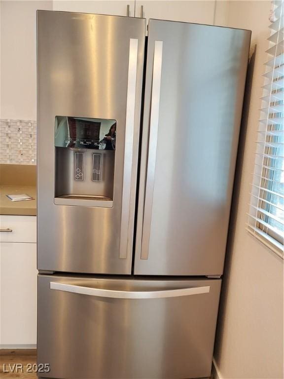 11251 Hidden Peak Ave Unit 212, Las Vegas, NV 89135 - room details with white cabinets and stainless steel refrigerator with ice dispenser