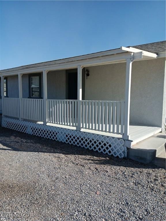 back of property with covered porch