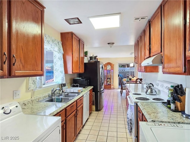 kitchen with dishwashing machine, white range with electric stovetop, sink, light tile patterned floors, and washer / clothes dryer