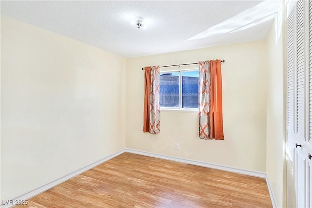 unfurnished bedroom featuring a textured ceiling, hardwood / wood-style flooring, and a closet