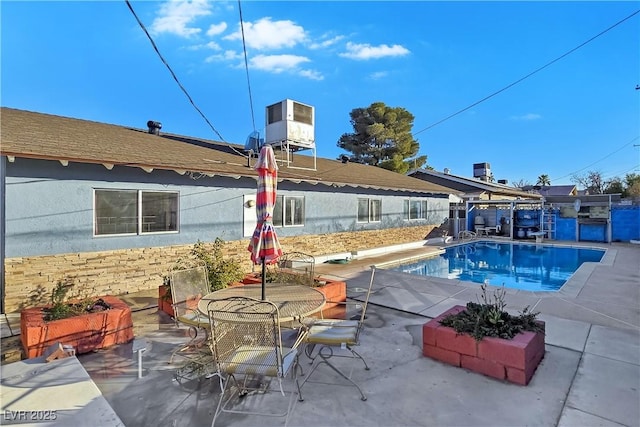 view of pool featuring a patio and cooling unit