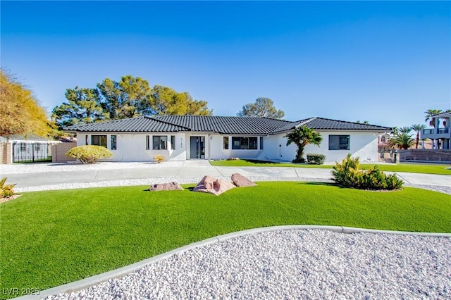 ranch-style home with a front lawn