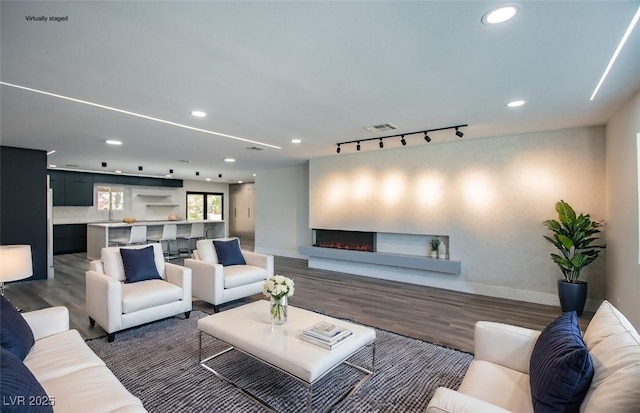 living room with dark wood-type flooring and sink