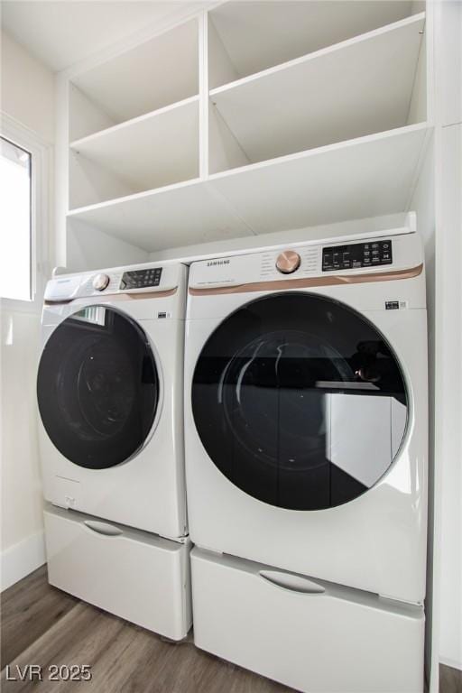 laundry room with separate washer and dryer and dark hardwood / wood-style flooring