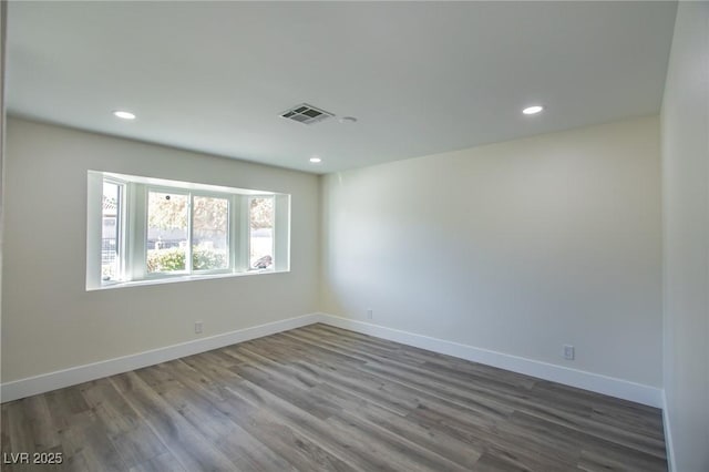 empty room with hardwood / wood-style flooring