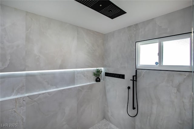 bathroom with tiled shower