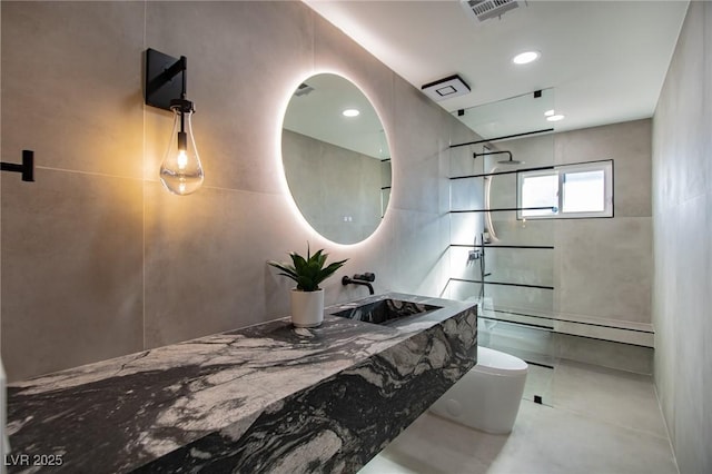 bathroom with toilet, sink, and walk in shower