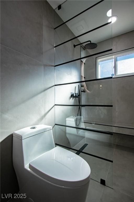 bathroom with a shower, tile patterned flooring, and toilet