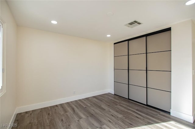 unfurnished bedroom featuring a closet and light hardwood / wood-style floors