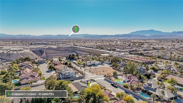 birds eye view of property with a mountain view