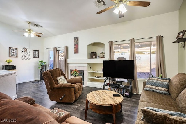 living room with dark hardwood / wood-style flooring, plenty of natural light, and a fireplace