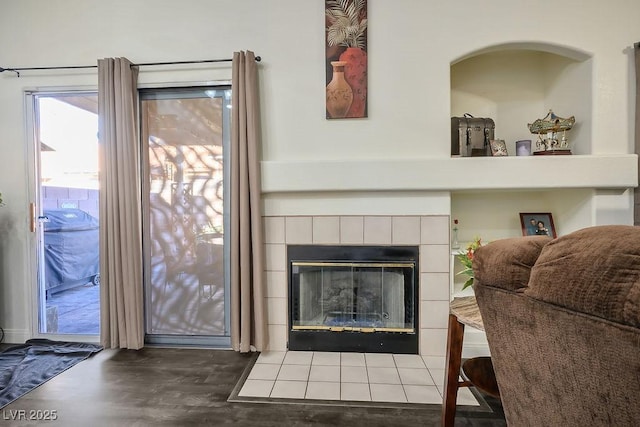 room details with a tile fireplace and hardwood / wood-style floors