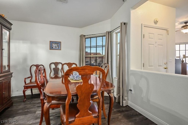 dining area featuring a healthy amount of sunlight and dark hardwood / wood-style floors