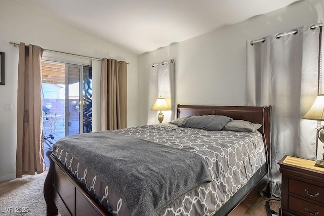 carpeted bedroom featuring access to outside and lofted ceiling