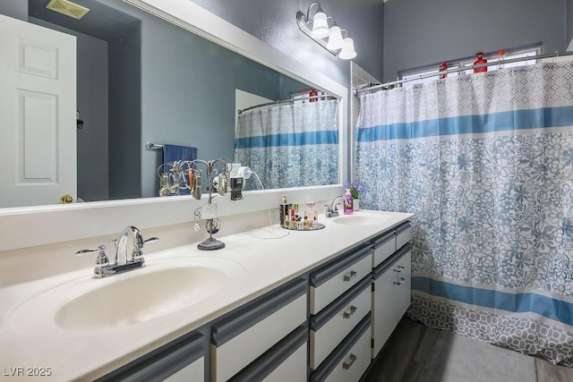 bathroom with vanity and curtained shower