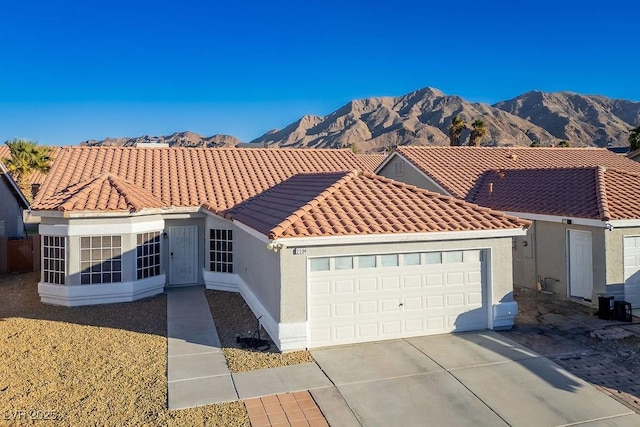 view of front facade with a mountain view and a garage