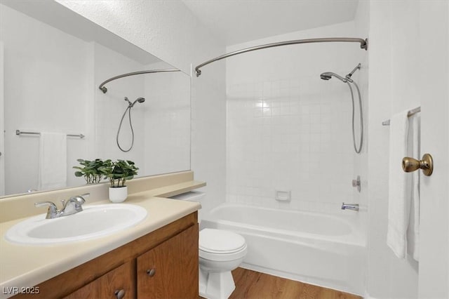 full bathroom with vanity, hardwood / wood-style flooring, toilet, and shower / bathtub combination