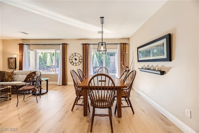 dining room with light hardwood / wood-style flooring and plenty of natural light