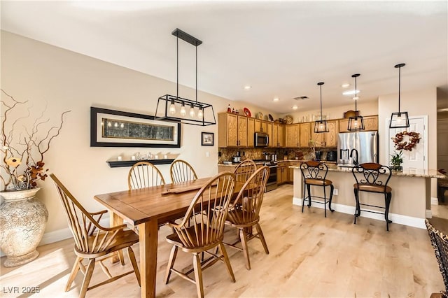 dining room with light hardwood / wood-style floors