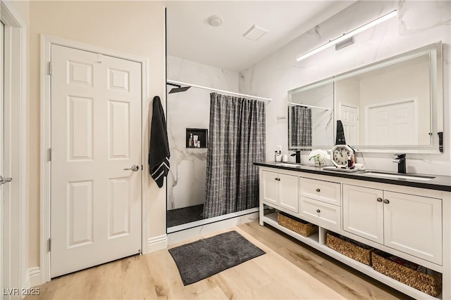 bathroom featuring vanity, wood-type flooring, and a shower with shower curtain