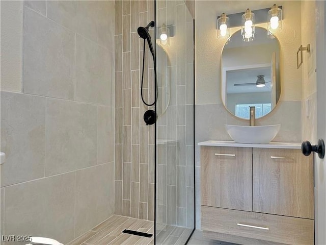 bathroom with vanity and a tile shower