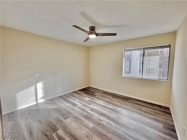 spare room featuring ceiling fan and light wood-type flooring