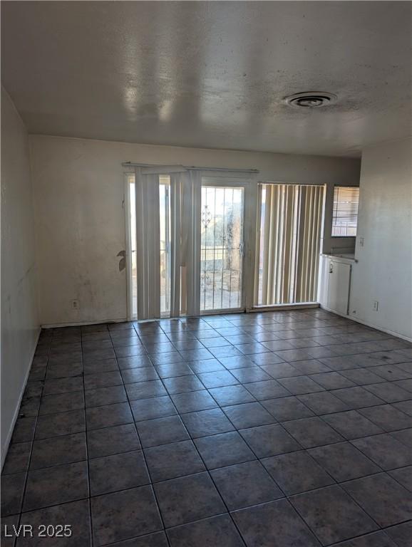 unfurnished room with a textured ceiling