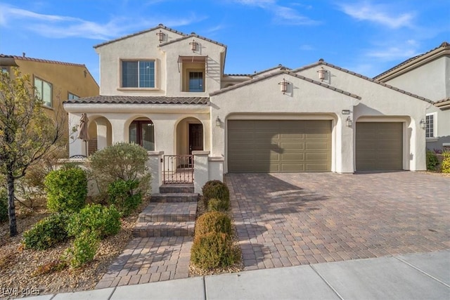 mediterranean / spanish-style house featuring covered porch and a garage