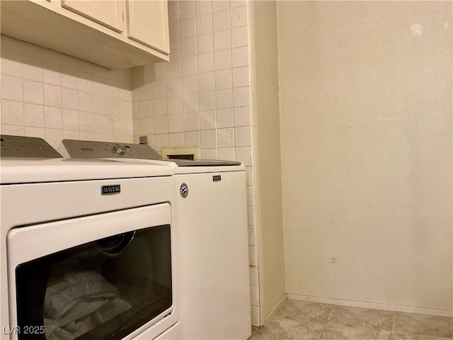 laundry room featuring cabinets and independent washer and dryer