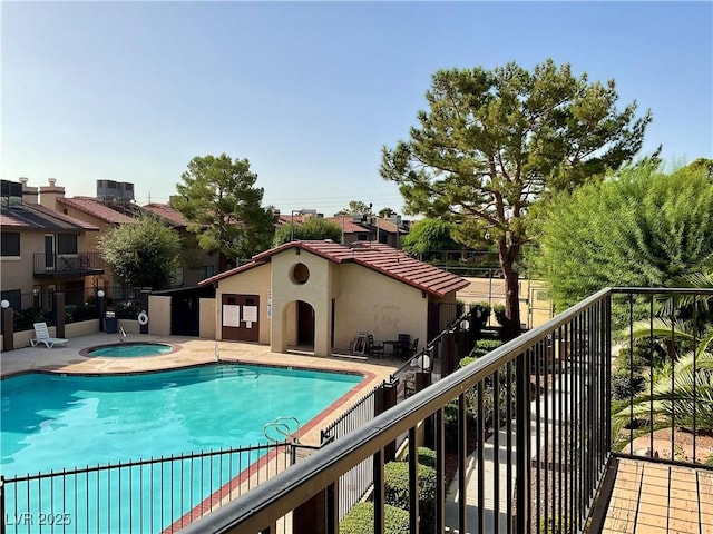 view of swimming pool with a hot tub and central AC unit