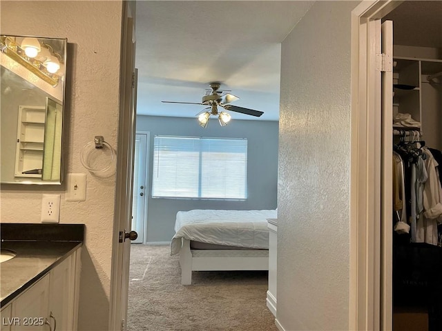 bedroom featuring ceiling fan, carpet floors, and a closet