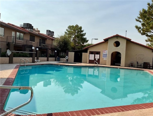 view of pool with central AC unit