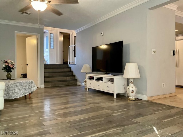 living room with crown molding, ceiling fan, and dark wood-type flooring