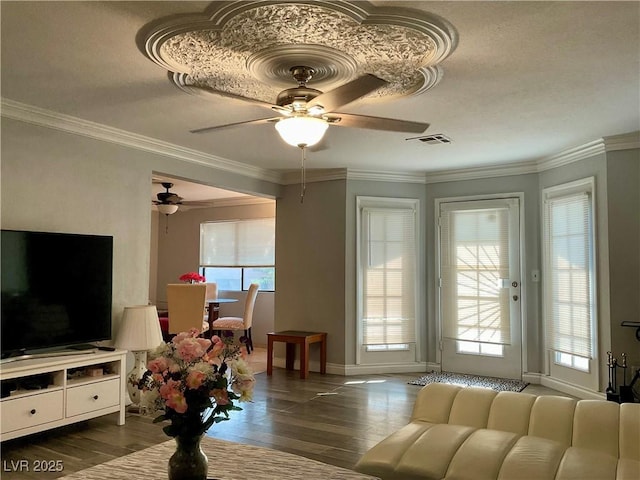 living room featuring dark hardwood / wood-style flooring, ceiling fan, and ornamental molding