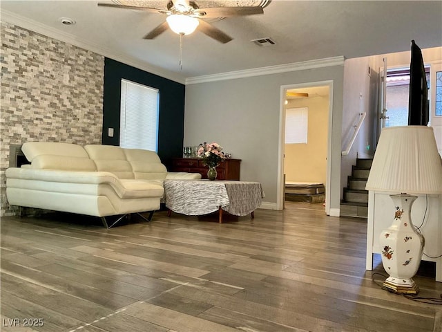 living room featuring ceiling fan, dark hardwood / wood-style floors, and ornamental molding