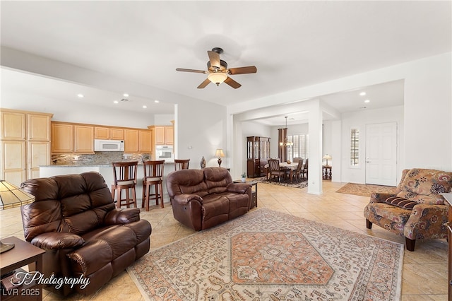 living room featuring light tile patterned flooring and ceiling fan