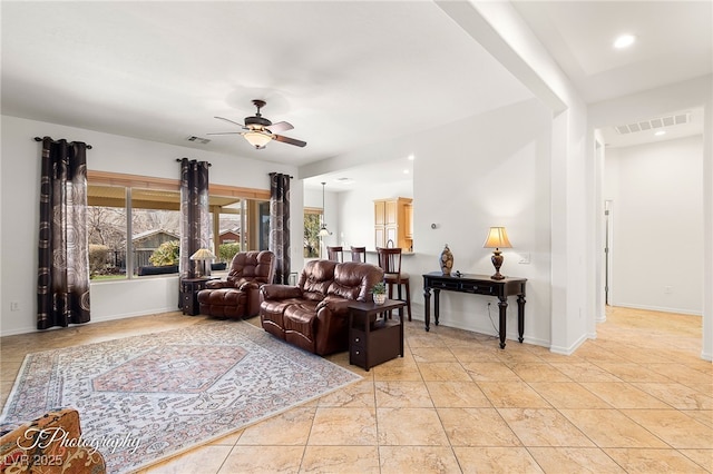 tiled living room featuring ceiling fan