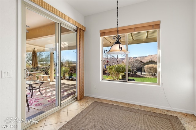 entryway with light tile patterned flooring and a wealth of natural light