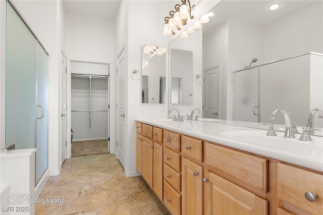 bathroom featuring a high ceiling, vanity, and a shower with shower door