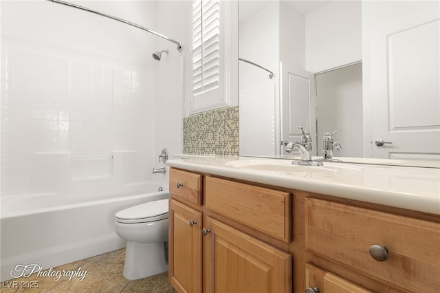 full bathroom featuring vanity, backsplash, toilet, and washtub / shower combination