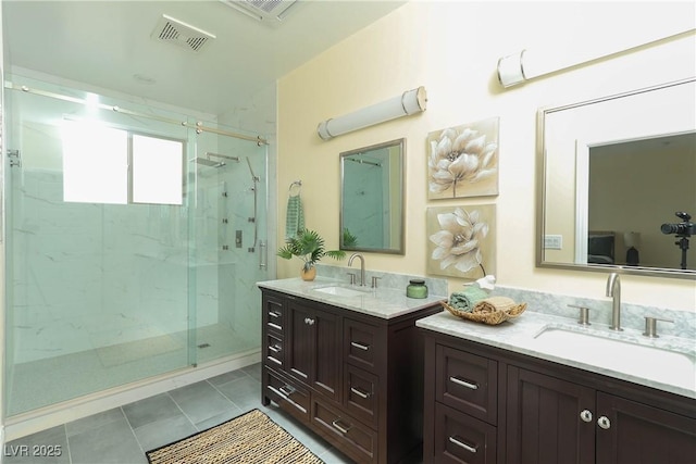 bathroom featuring a shower with door, tile patterned flooring, and vanity