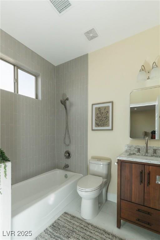 full bathroom featuring toilet, tiled shower / bath, and vanity