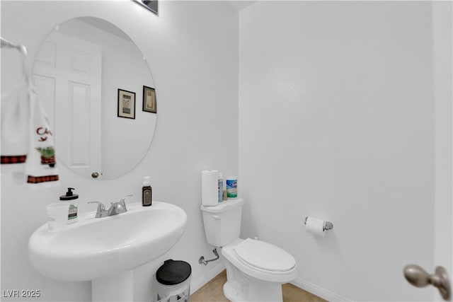 bathroom featuring sink, tile patterned flooring, and toilet