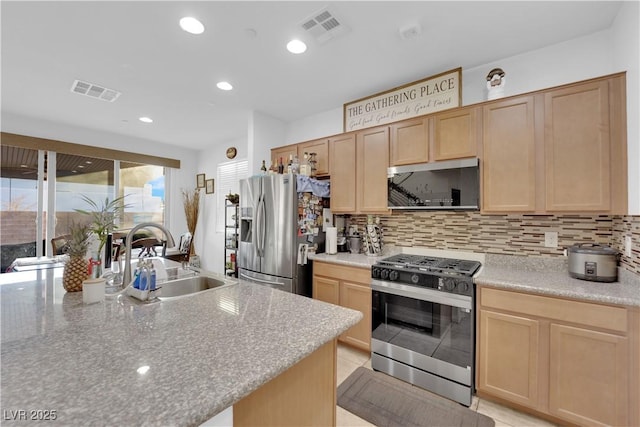 kitchen with appliances with stainless steel finishes, light brown cabinetry, and sink