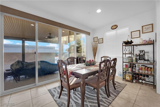 tiled dining space featuring ceiling fan