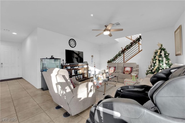 living room featuring light tile patterned floors and ceiling fan